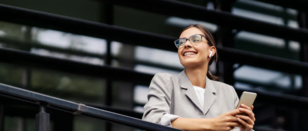 A businesswoman smiling while on her phone