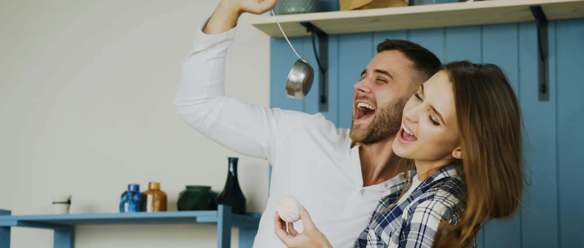 A couple celebrating together in their kitchen