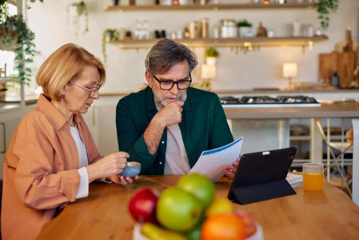 A couple reviewing their home loan paperwork at the kitchen table